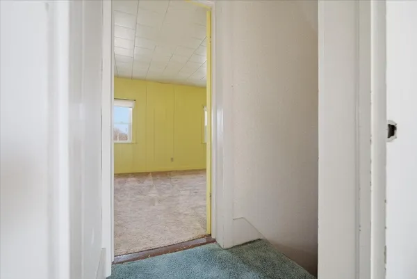 a view of a bathroom from a hallway
