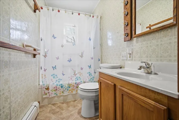 a view of walk in closet with window and a refrigerator