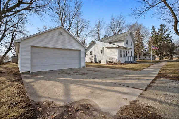 a front view of a house with a yard covered in snow