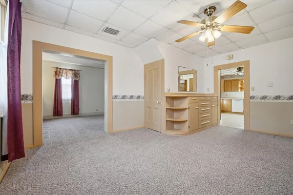 a view of a livingroom with a chandelier fan