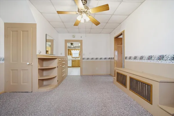 a view of a kitchen with a sink and dishwasher cabinet with a living room