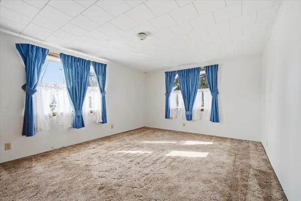 a view of an empty room with a fireplace