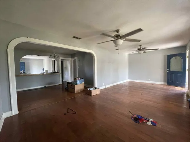 an empty room with cabinet and wooden floor
