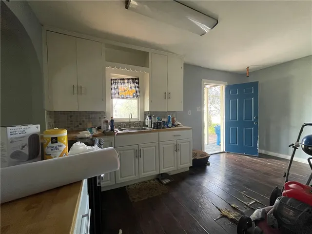 a kitchen with a wooden floor and a sink