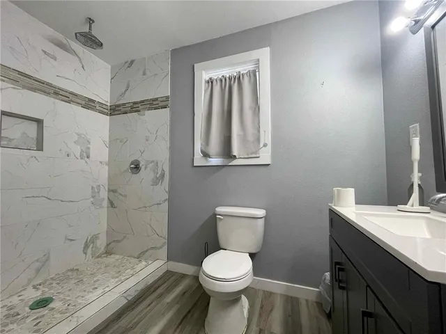 a bathroom with a toilet sink and shower