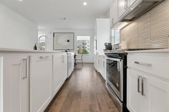 a kitchen with a sink stove and cabinets