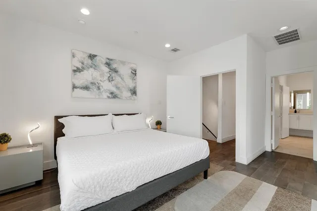 a view of a dining room with furniture and a kitchen view