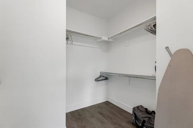 a large white bed sitting in a room next to a window