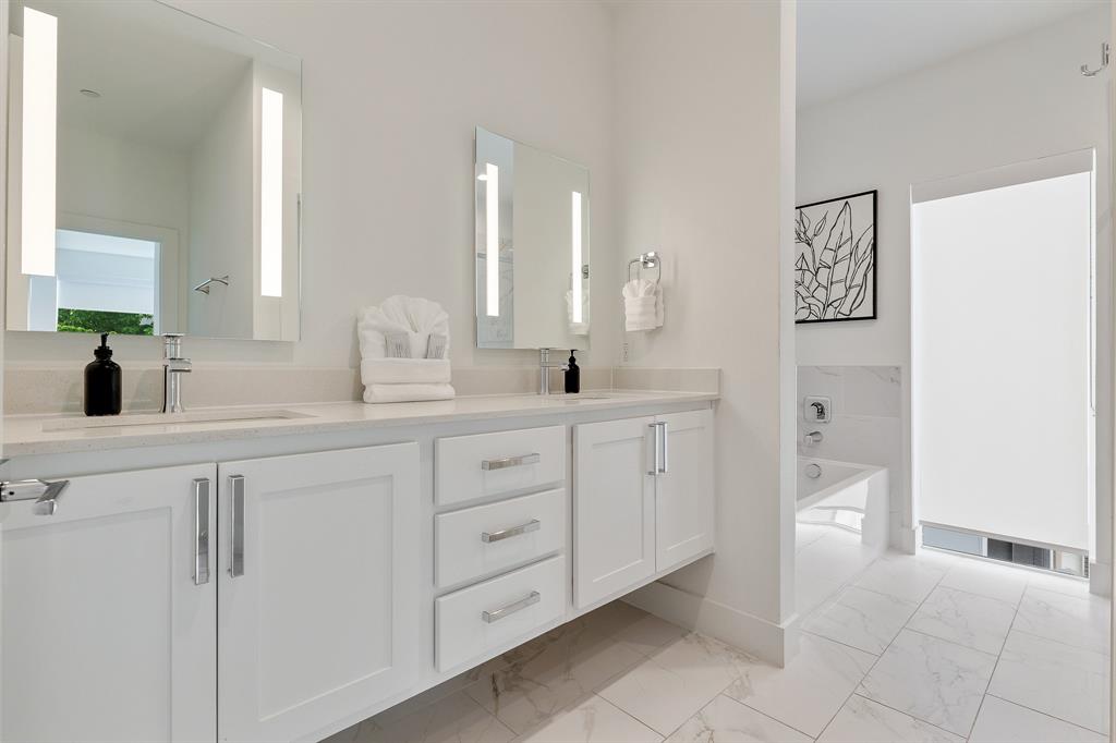 1771 Mccoy Street, Unit 401 Dallas, TX 75204 - Photo 16 of 30 Full bathroom with double vanity, a garden tub, and light marble finish floors