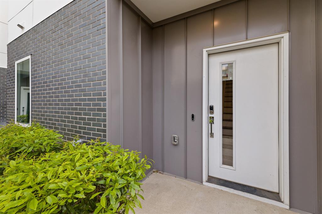1771 Mccoy Street, Unit 401 Dallas, TX 75204 - Photo 3 of 30 Property entrance with board and batten siding and brick siding