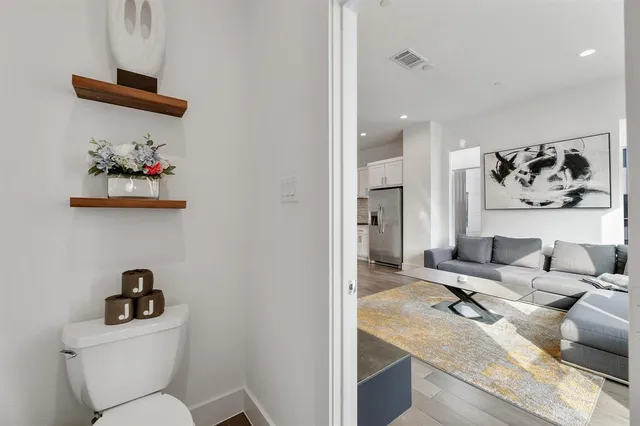 a living room with furniture and a painting on the wall