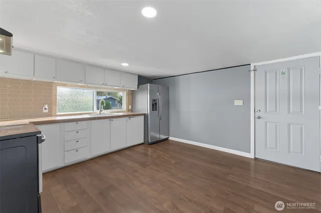 a view of a kitchen with electric appliances