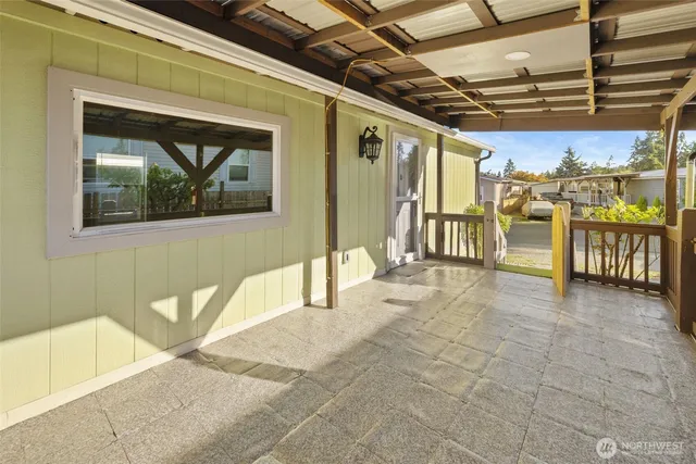 a view of a porch with a table and chairs