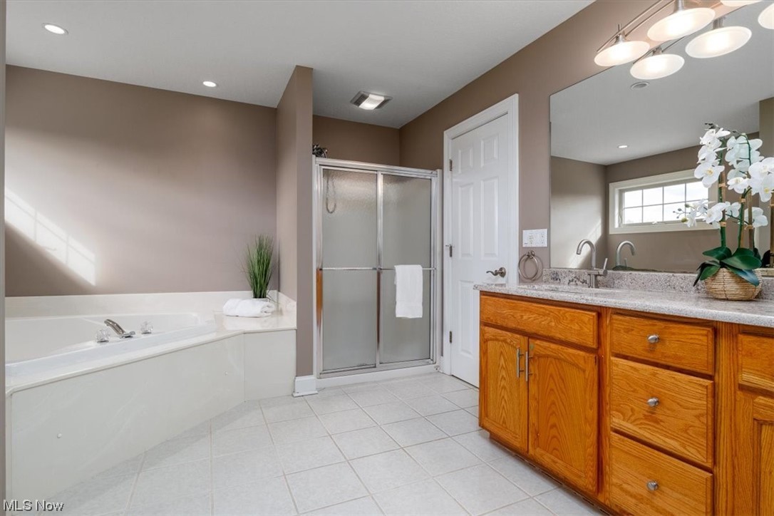 514 Silver Ridge Drive Akron, OH 44321 - Photo 24 of 47 The primary bathroom also features a stand-alone shower and double vanity.