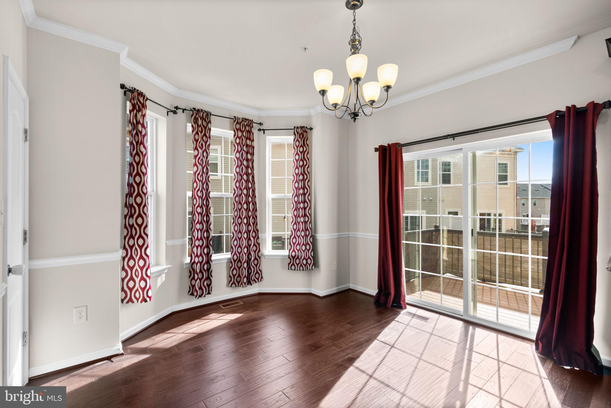 7977 Alchemy Way Elkridge, MD 21075 - Photo 12 of 33 a view of an empty room with wooden floor and a window