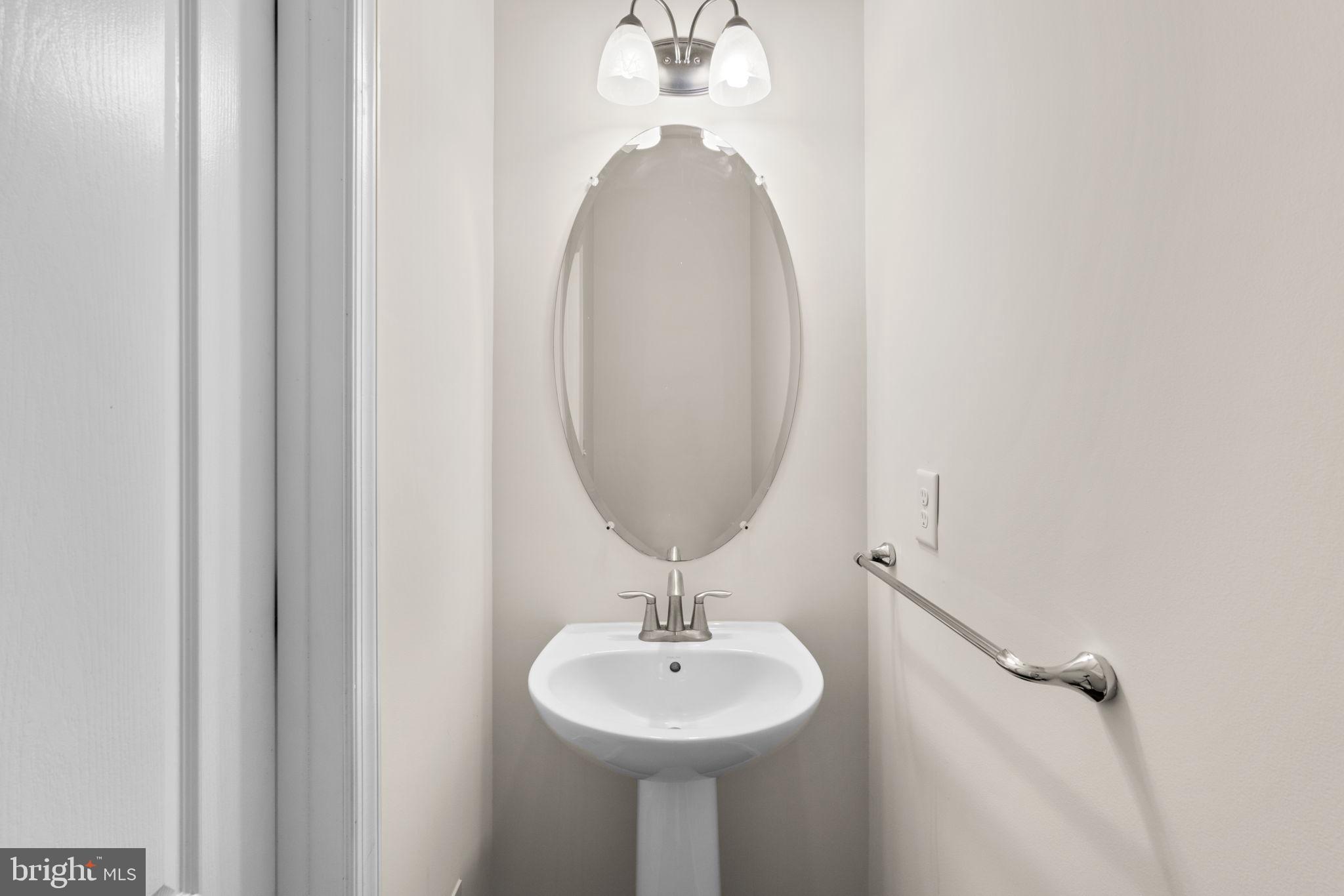 7977 Alchemy Way Elkridge, MD 21075 - Photo 13 of 33 a bathroom with a sink and a mirror