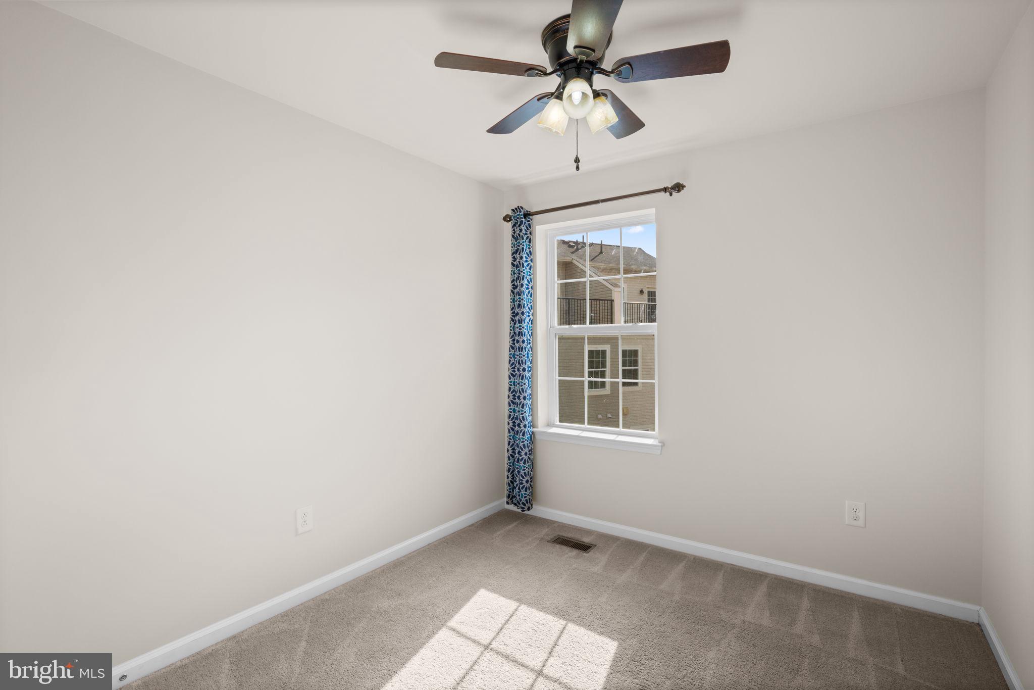 7977 Alchemy Way Elkridge, MD 21075 - Photo 21 of 33 an empty room with windows and fan