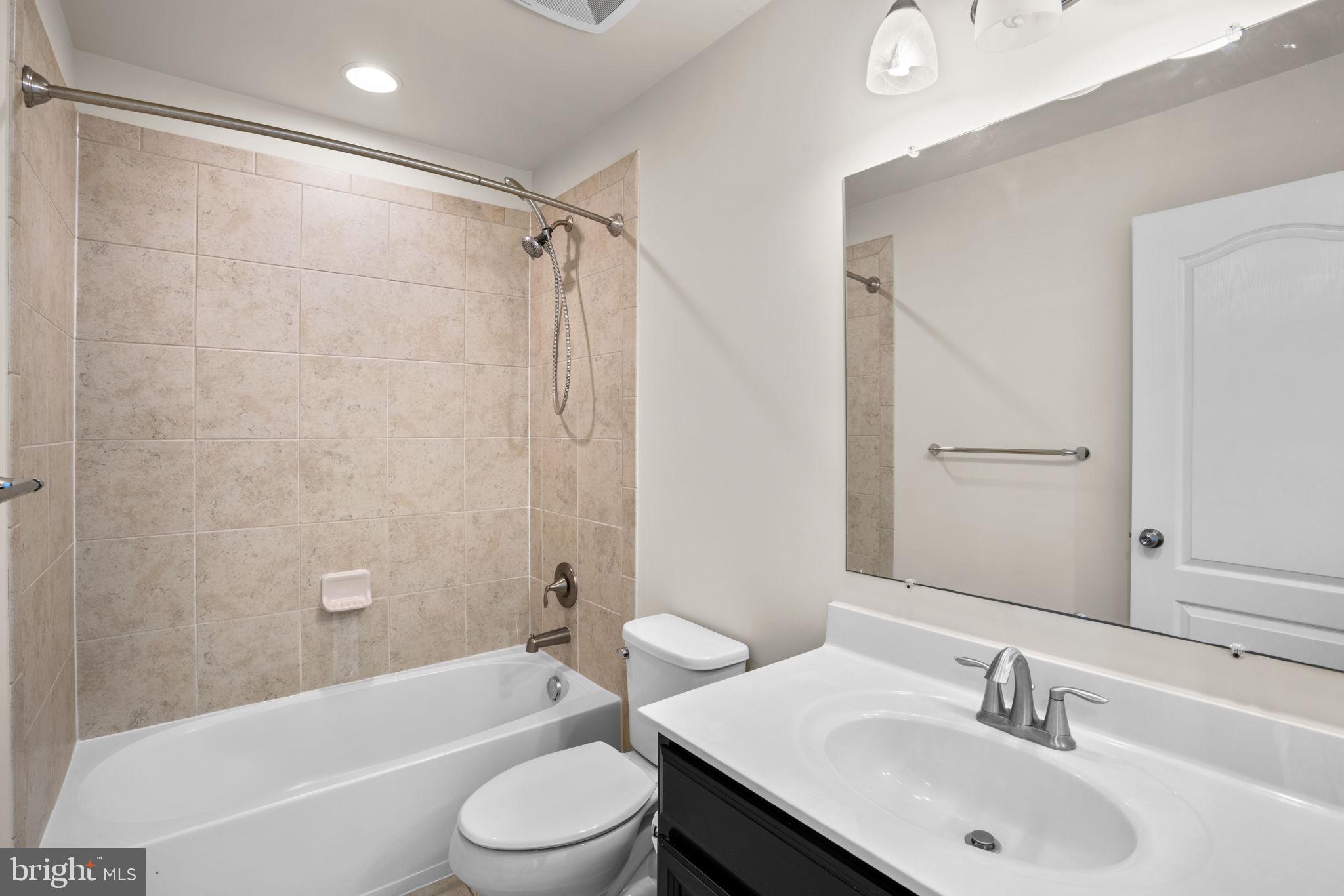 7977 Alchemy Way Elkridge, MD 21075 - Photo 22 of 33 a bathroom with a sink a toilet and a bathtub
