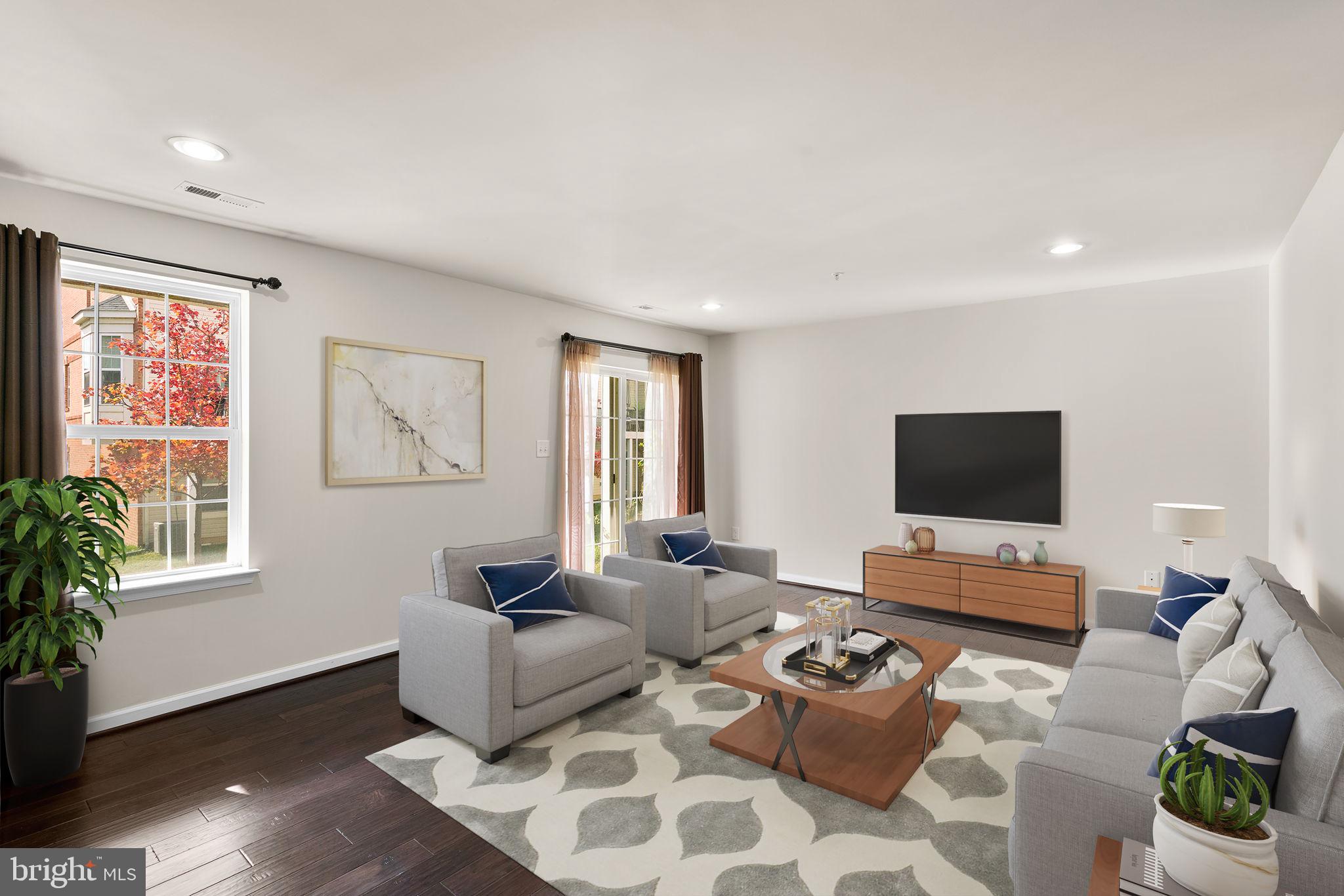 7977 Alchemy Way Elkridge, MD 21075 - Photo 24 of 33 a living room with furniture and a flat screen tv