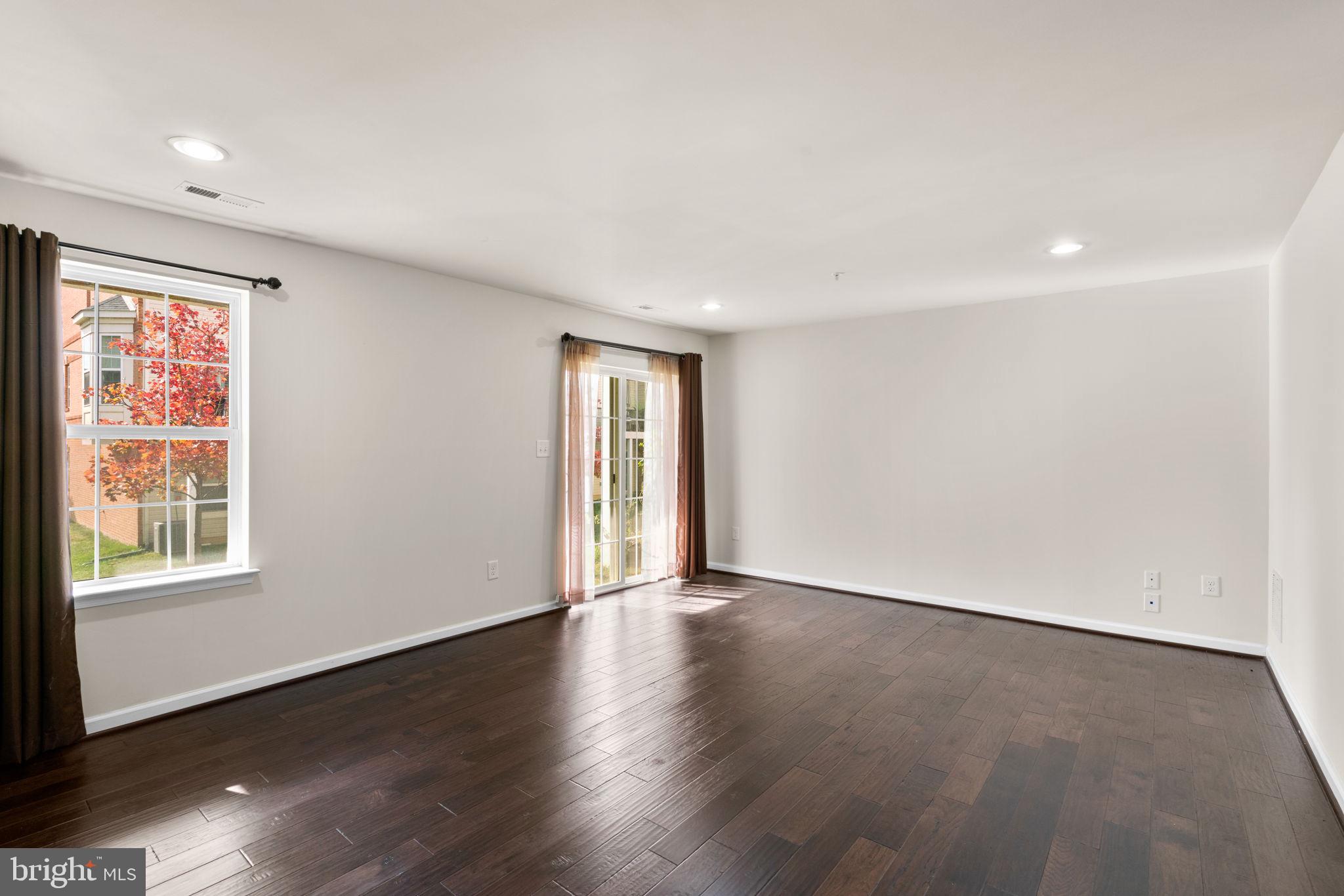 7977 Alchemy Way Elkridge, MD 21075 - Photo 25 of 33 an empty room with wooden floor and windows