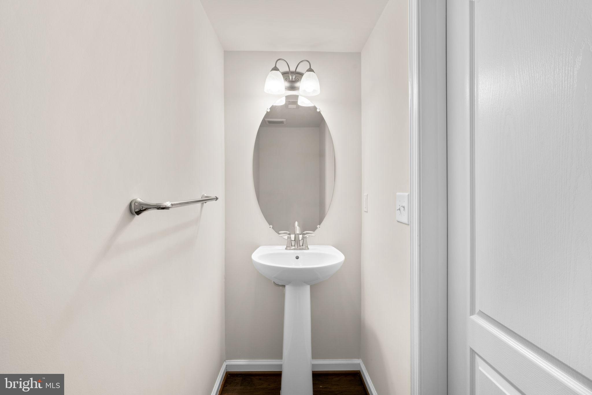 7977 Alchemy Way Elkridge, MD 21075 - Photo 26 of 33 a bathroom with a sink and a mirror
