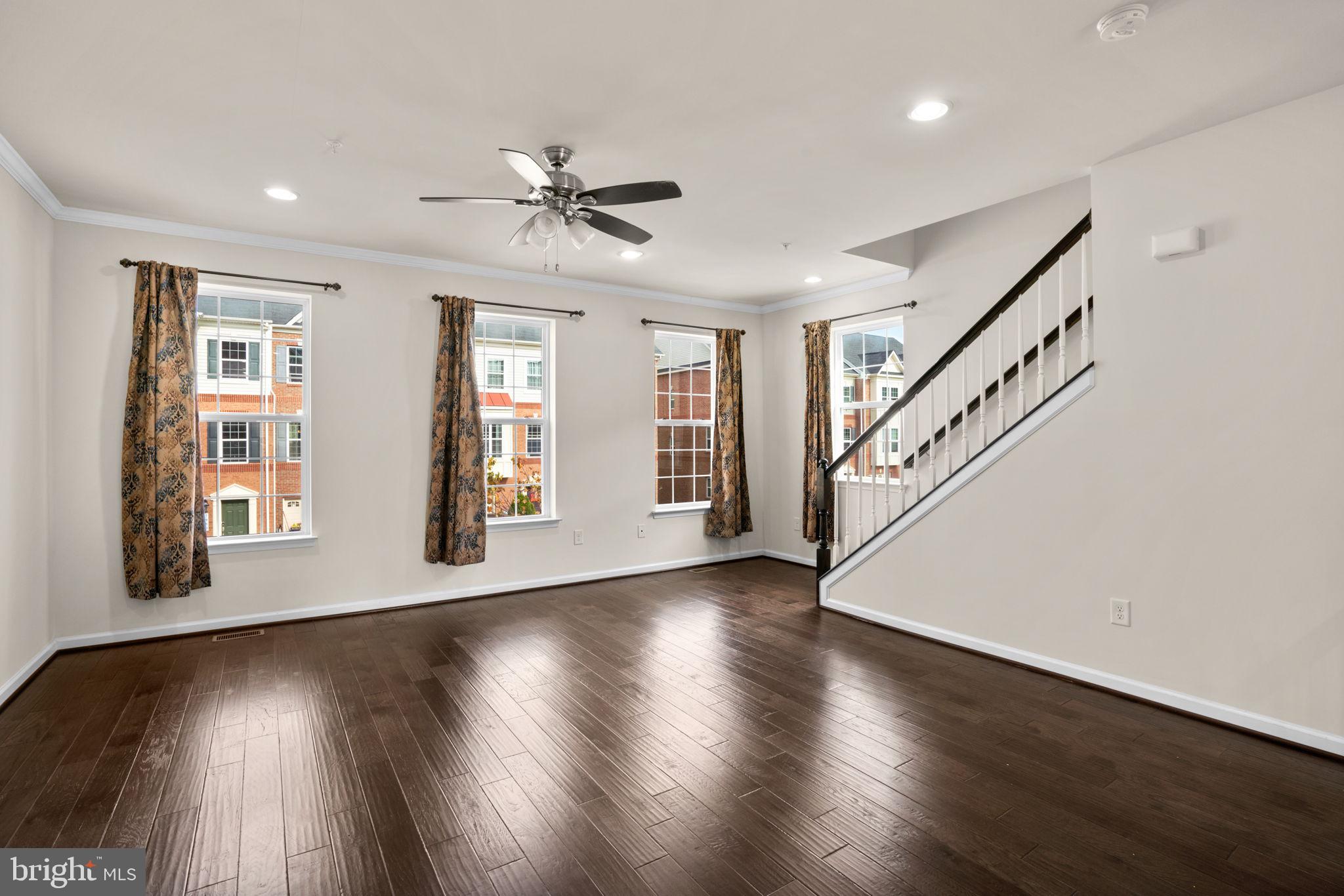7977 Alchemy Way Elkridge, MD 21075 - Photo 4 of 33 a view of an empty room with wooden floor and a window
