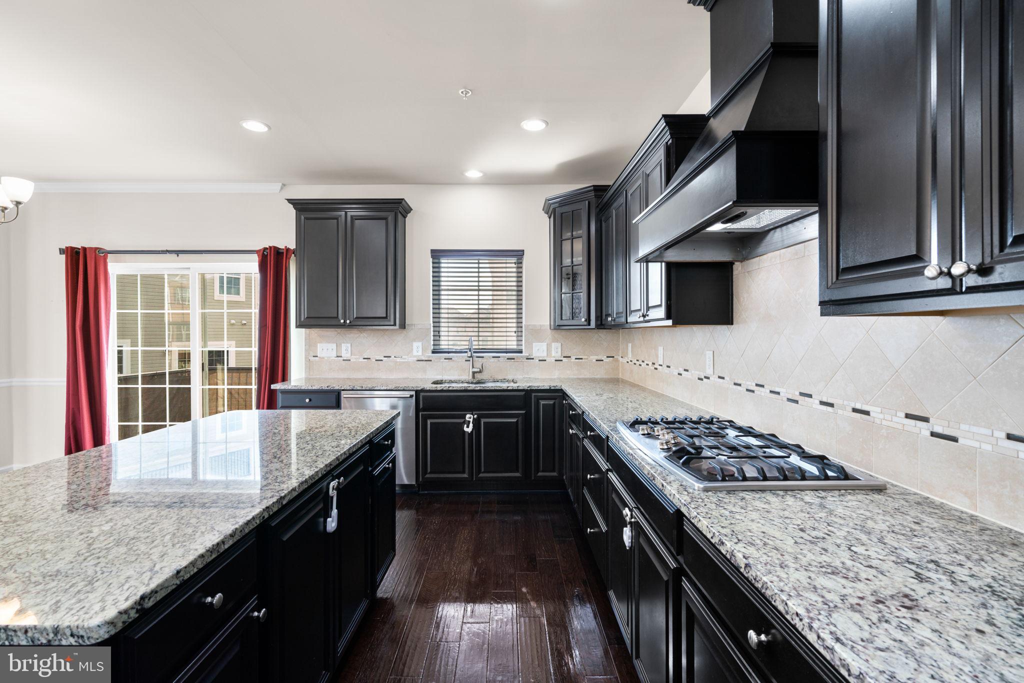 7977 Alchemy Way Elkridge, MD 21075 - Photo 7 of 33 a kitchen with stainless steel appliances granite countertop a sink stove and refrigerator