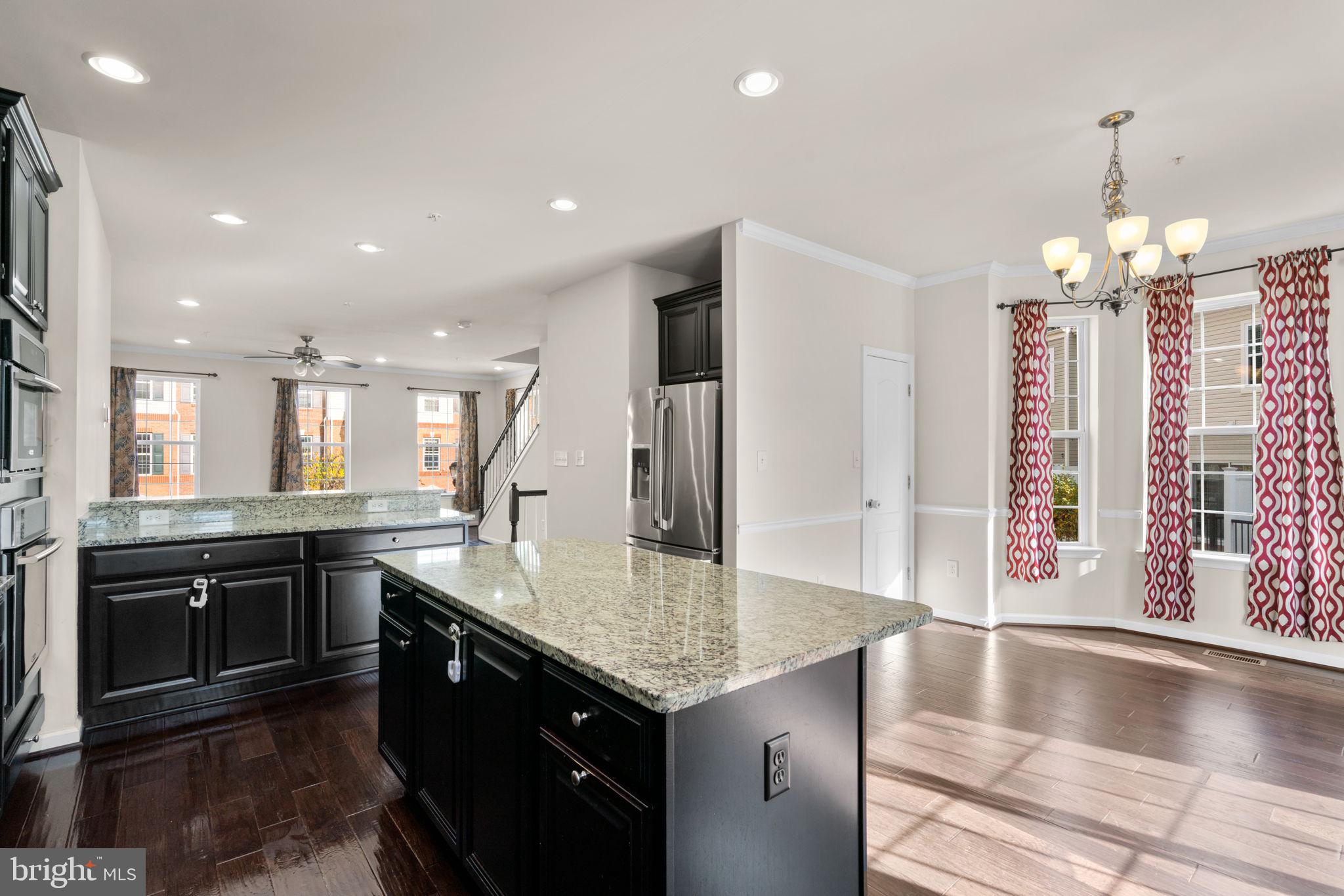 7977 Alchemy Way Elkridge, MD 21075 - Photo 8 of 33 a kitchen with stainless steel appliances granite countertop a stove and a sink