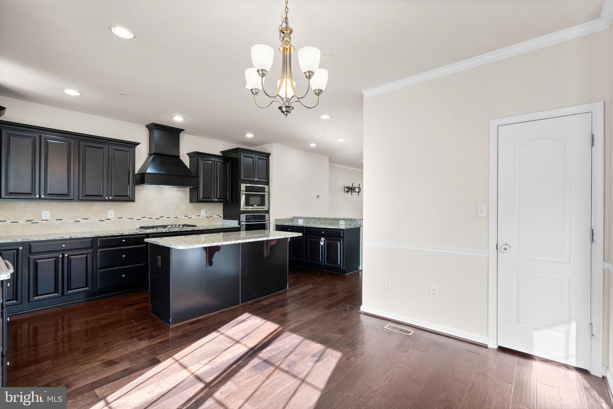 7977 Alchemy Way Elkridge, MD 21075 - Photo 9 of 33 a large kitchen with a sink and stainless steel appliances