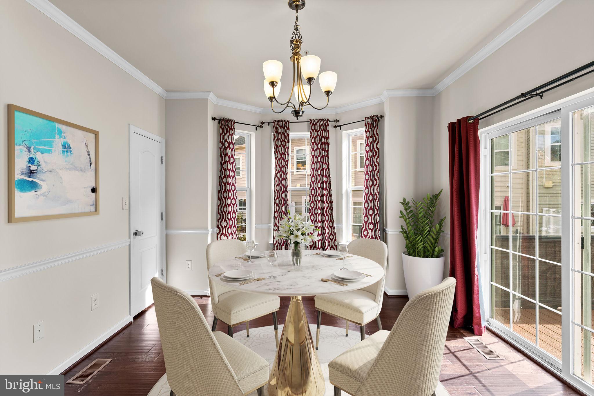 7977 Alchemy Way Elkridge, MD 21075 - Photo 10 of 33 a view of a dining room with furniture large windows and wooden floor
