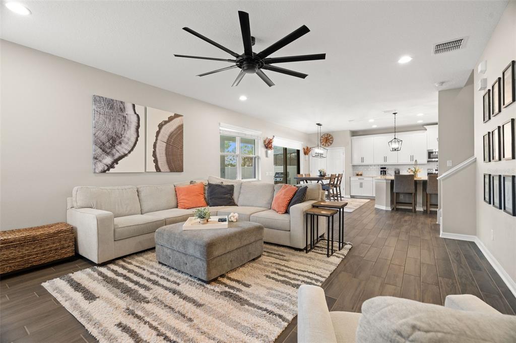 1216 Multiflora Loop Lutz, FL 33558 - Photo 13 of 50 a living room with furniture kitchen view and a wooden floor