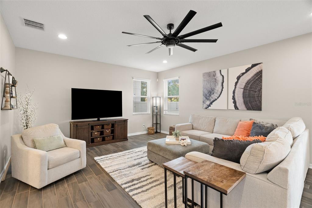 1216 Multiflora Loop Lutz, FL 33558 - Photo 15 of 50 a living room with furniture and a flat screen tv