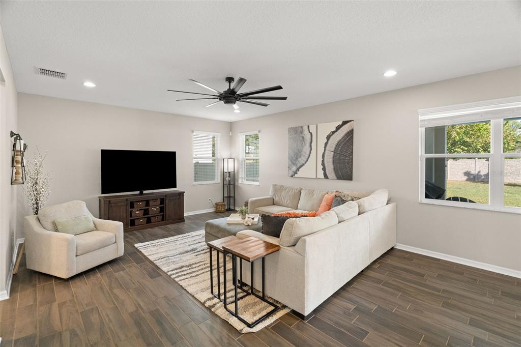 1216 Multiflora Loop Lutz, FL 33558 - Photo 16 of 50 a living room with furniture and a flat screen tv