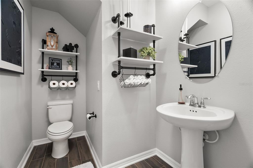 1216 Multiflora Loop Lutz, FL 33558 - Photo 18 of 50 a bathroom with a toilet sink and mirror