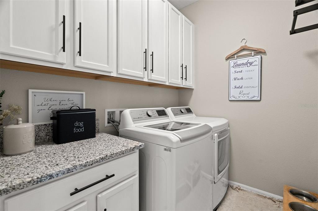 1216 Multiflora Loop Lutz, FL 33558 - Photo 19 of 50 a view of cabinets and washer dryer