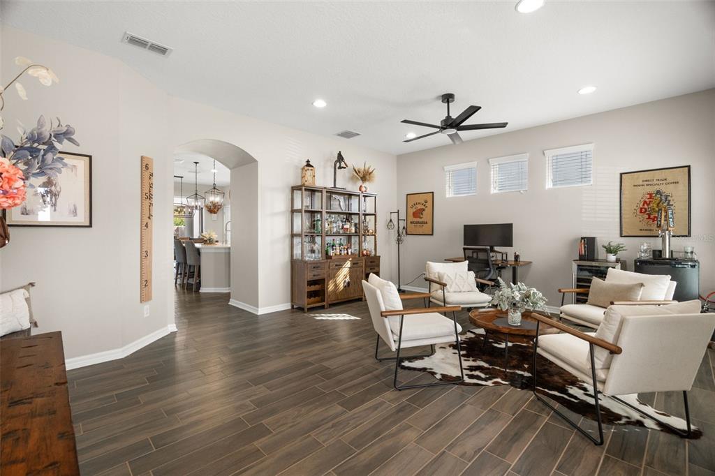 1216 Multiflora Loop Lutz, FL 33558 - Photo 2 of 50 a living room with furniture a rug and a chandelier