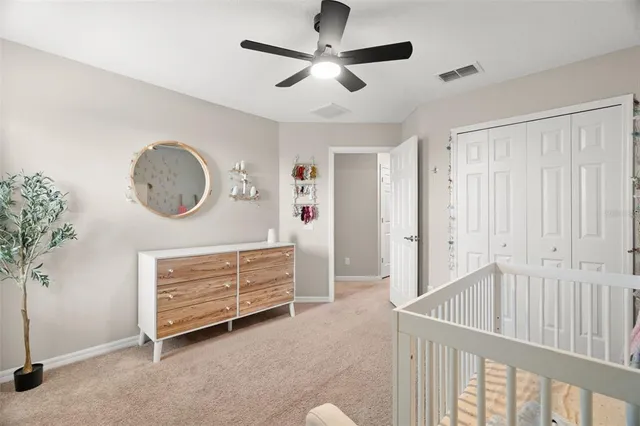 a view of a hallway to a livingroom with furniture