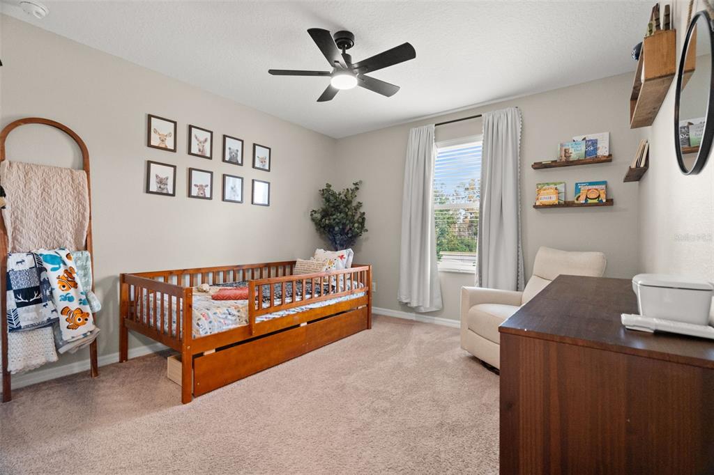 1216 Multiflora Loop Lutz, FL 33558 - Photo 25 of 50 a bedroom with furniture and a window