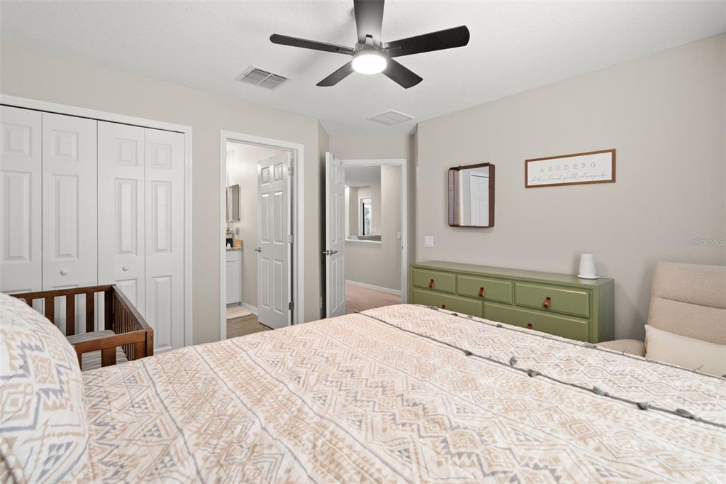 1216 Multiflora Loop Lutz, FL 33558 - Photo 28 of 50 a bedroom with a bed and a walk in closet