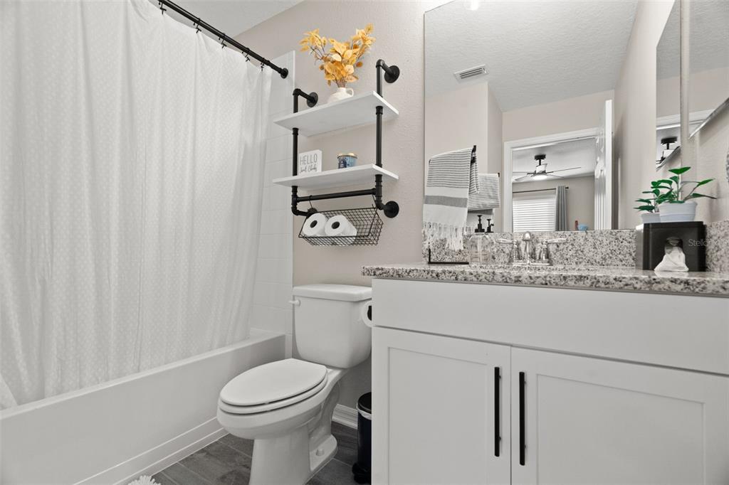 1216 Multiflora Loop Lutz, FL 33558 - Photo 29 of 50 a bathroom with a sink a toilet and shower