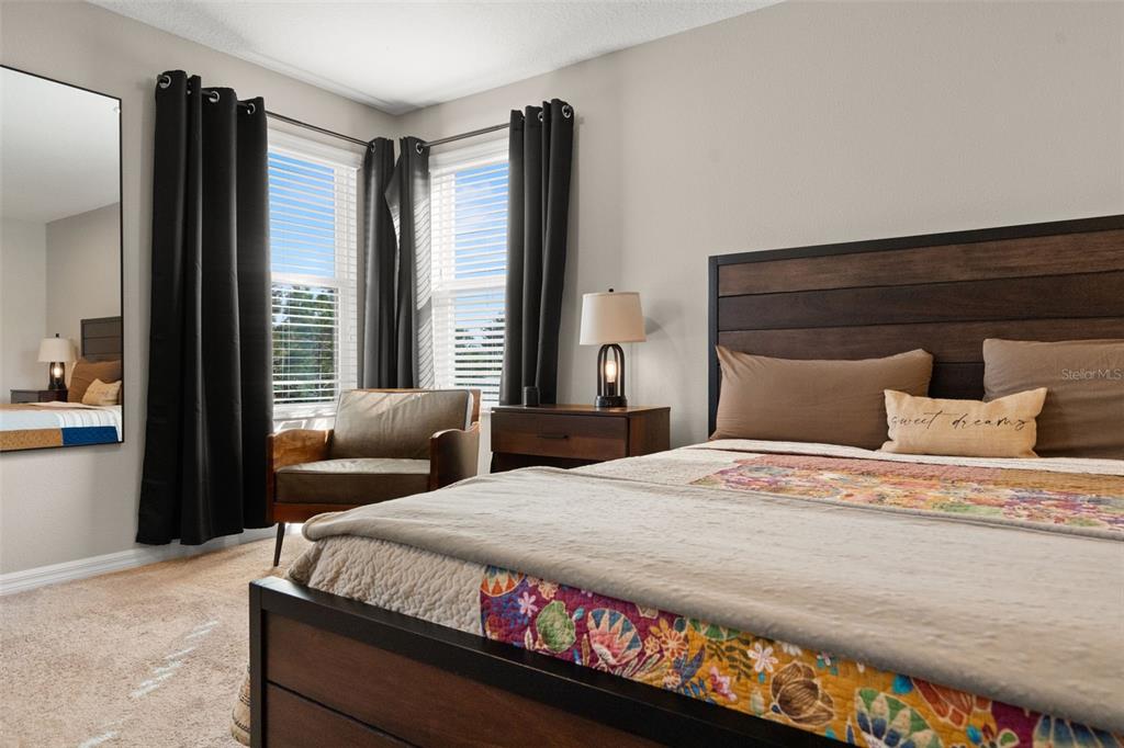 1216 Multiflora Loop Lutz, FL 33558 - Photo 33 of 50 a bedroom with a bed and wooden floor