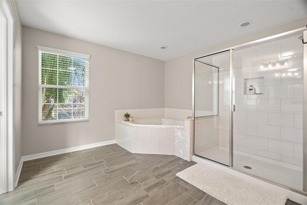 1216 Multiflora Loop Lutz, FL 33558 - Photo 36 of 50 a bathroom with a bathtub and a shower