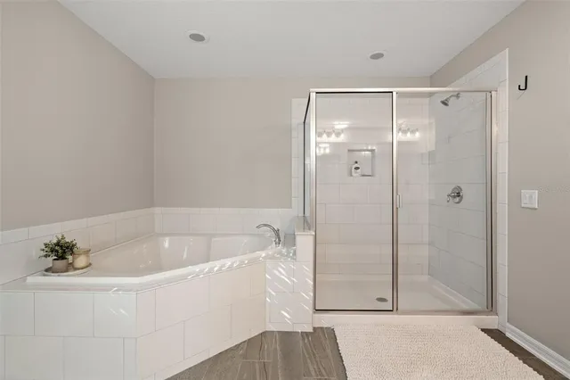 a white bath tub sitting next to a shower