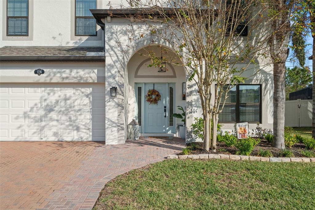 1216 Multiflora Loop Lutz, FL 33558 - Photo 44 of 50 a front view of a house with garden