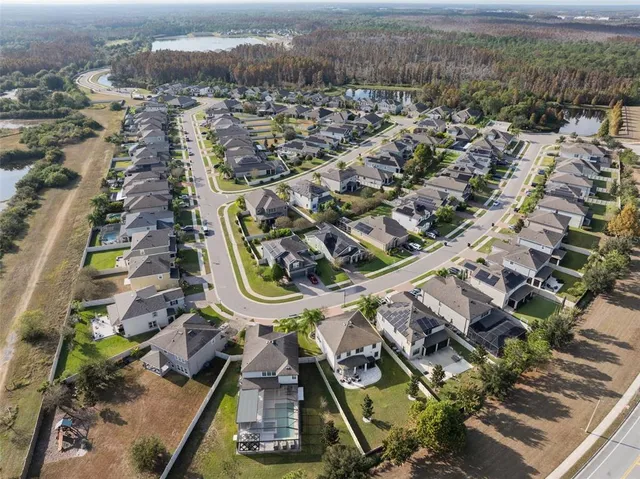 an aerial view of residential houses with outdoor space