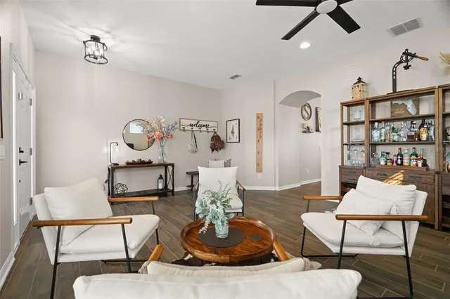 a living room with furniture and wooden floor