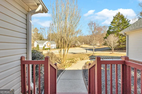 a bedroom with a bed table closet and a flat tv screen