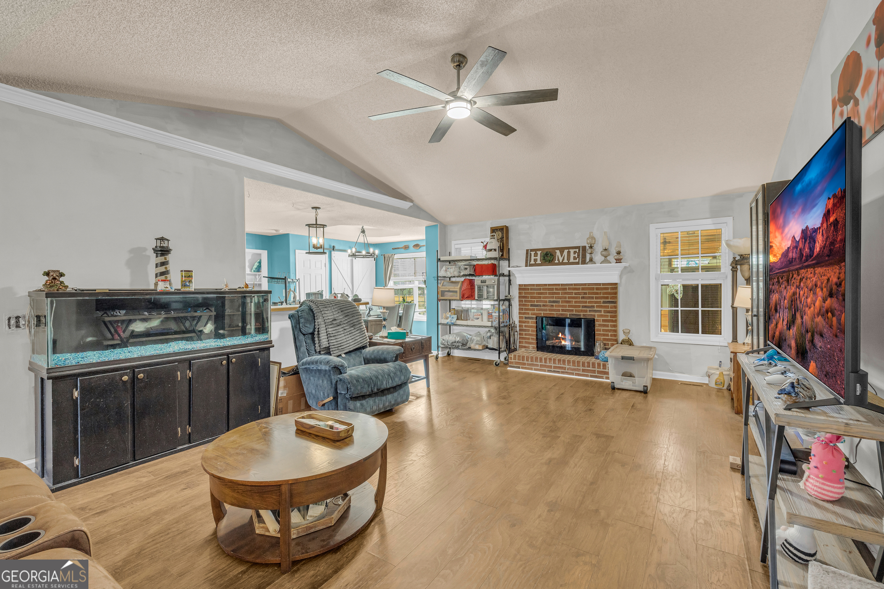 139 Silverstone Circle Jefferson, GA 30549 - Photo 35 of 85 a living room with furniture a fireplace and a flat screen tv