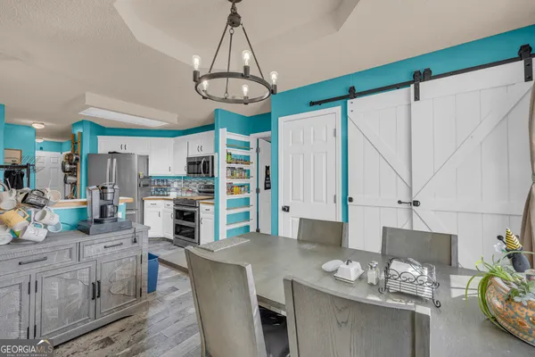 a kitchen with stainless steel appliances granite countertop a refrigerator a stove and a sink with cabinets