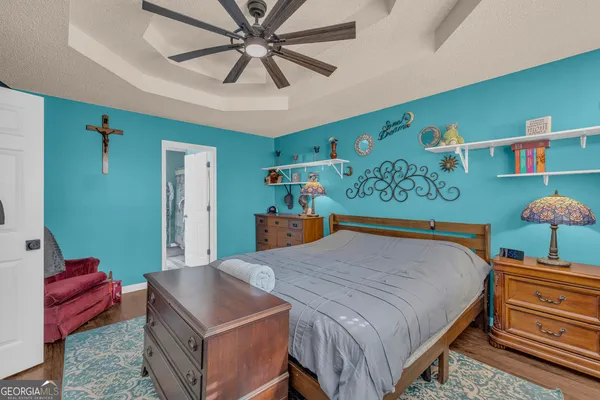 a bathroom with a granite countertop sink a toilet and a mirror